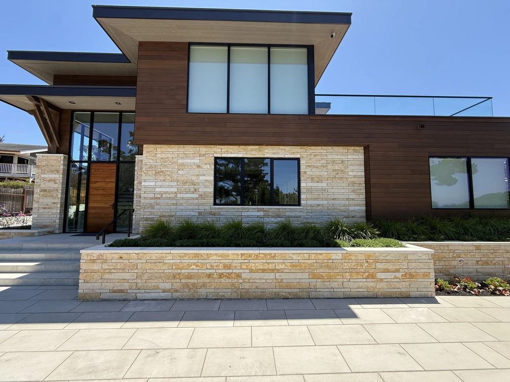 Modern stone-and-wood home built by Masonry Masters LLC